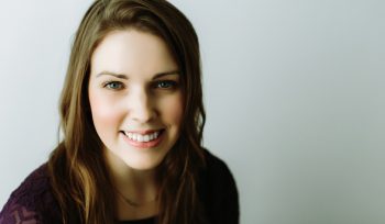 megan maltby a portland lactation consultant long hair smiling with blurry greay background